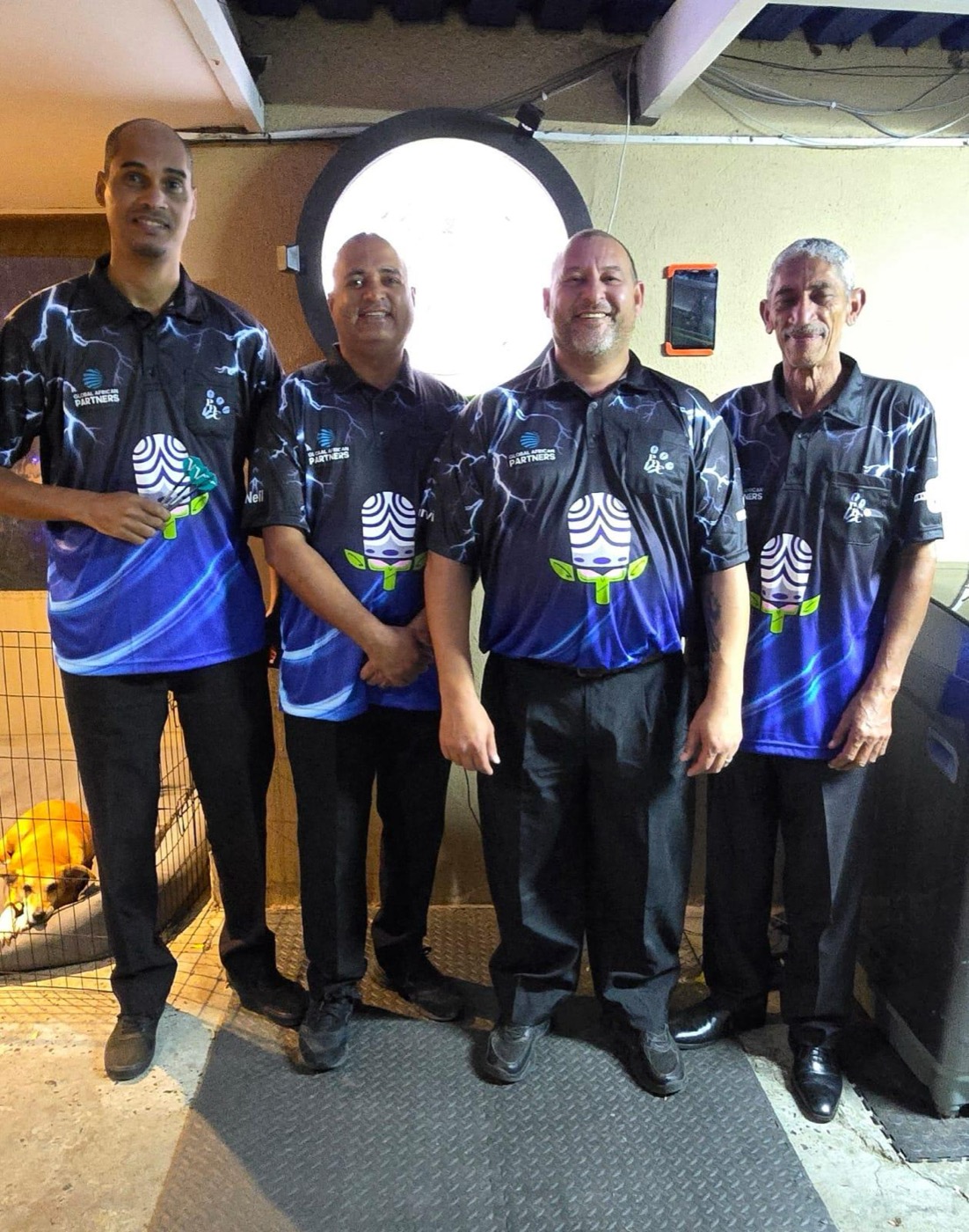 Four Parklands Dart Club players standing together in the club's blue playing shirts
