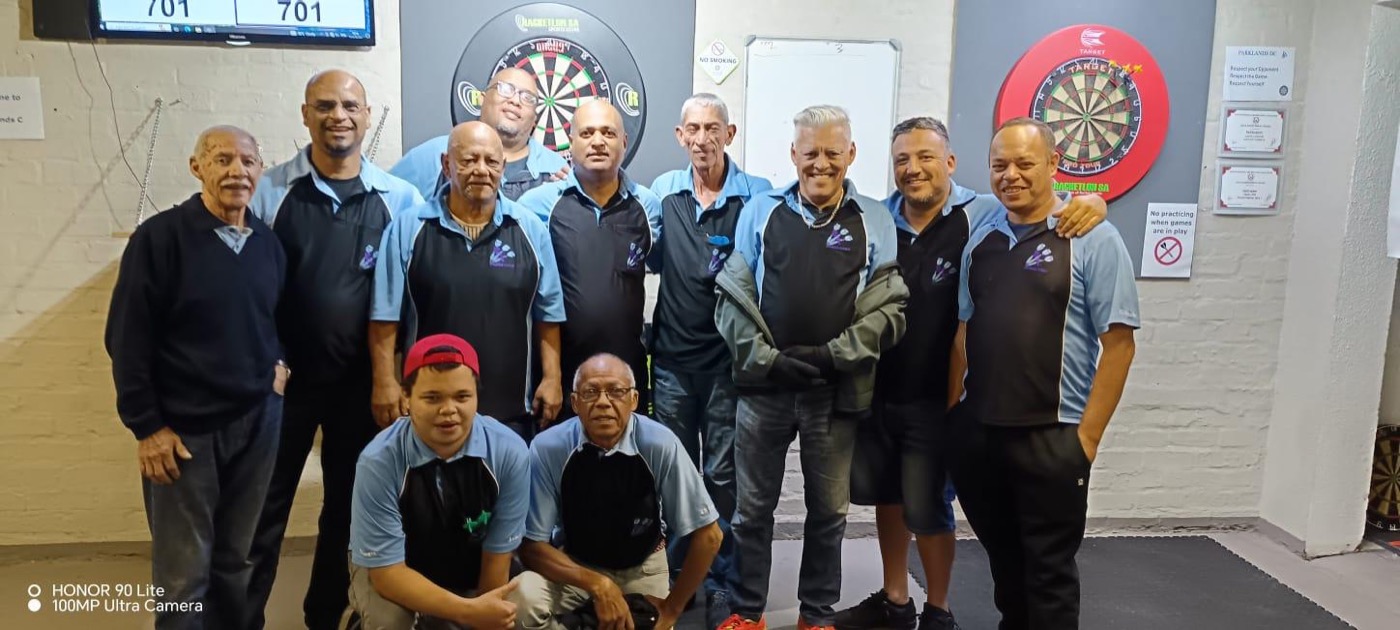The club squad lined up in front of the dartboards at the club venue